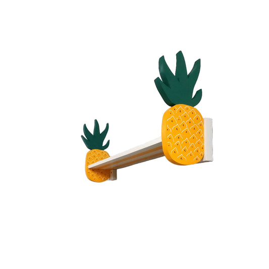 Pineapple-shaped wall shelf on a white wall