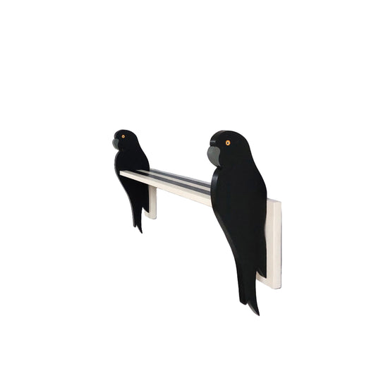 A wall shelf with parrot shaped brackets